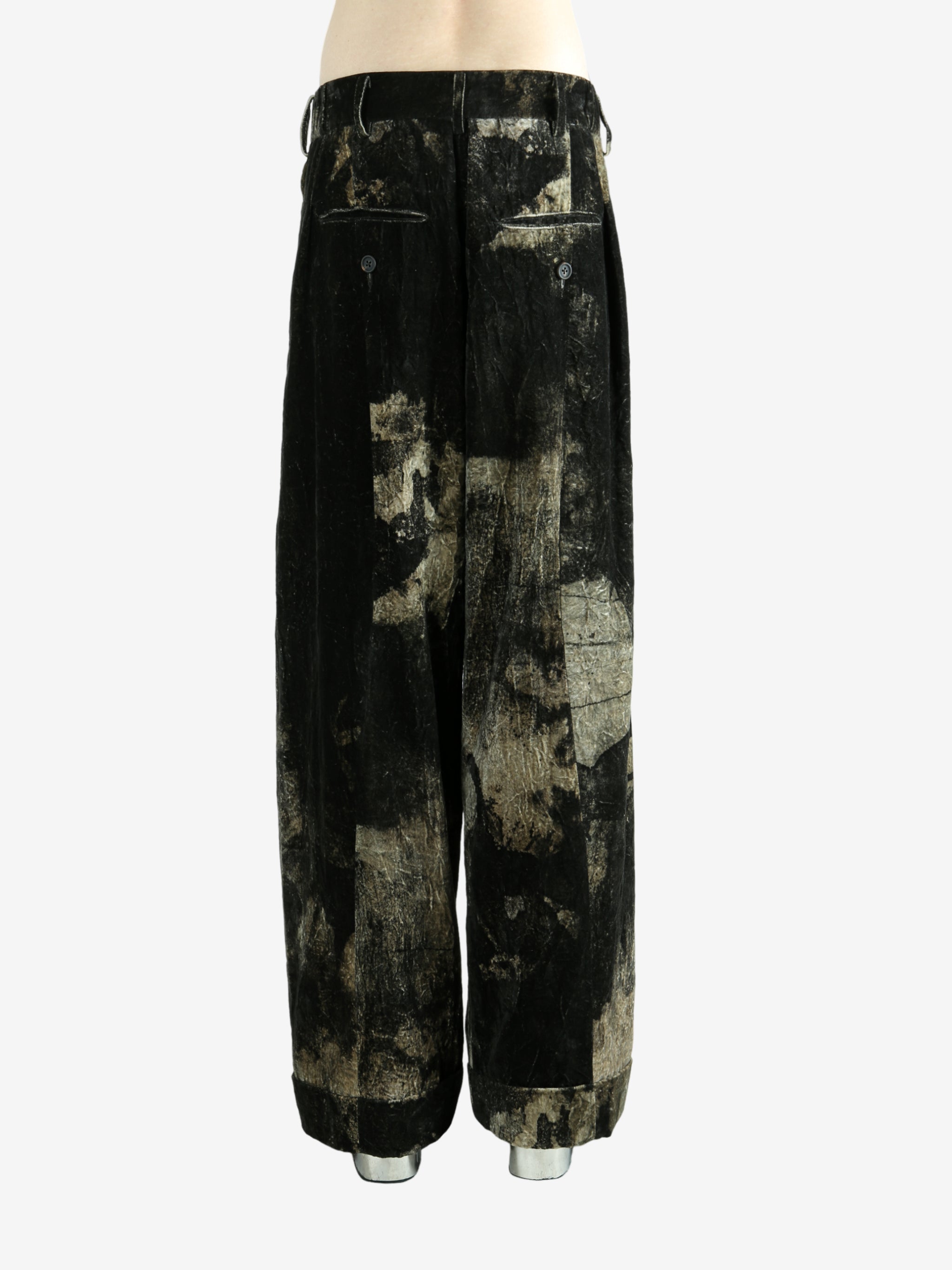 Black pants worn by a person, showing the pants fit