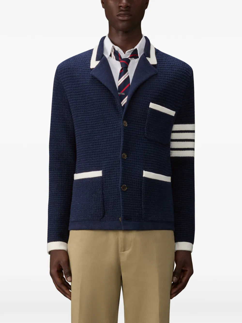 Navy knitwear worn by a person, showing the knitwear fit