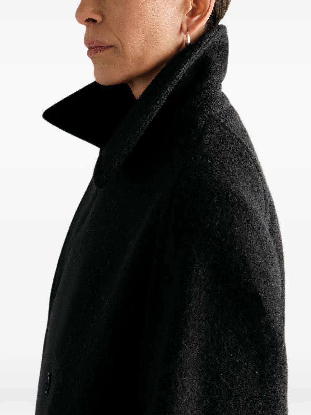 Black jacket worn by a person, showing the jacket fit