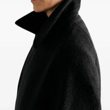 Black jacket worn by a person, showing the jacket fit