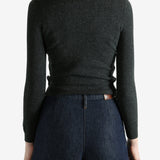 Grey sweater worn by a person, showing the sweater's fit