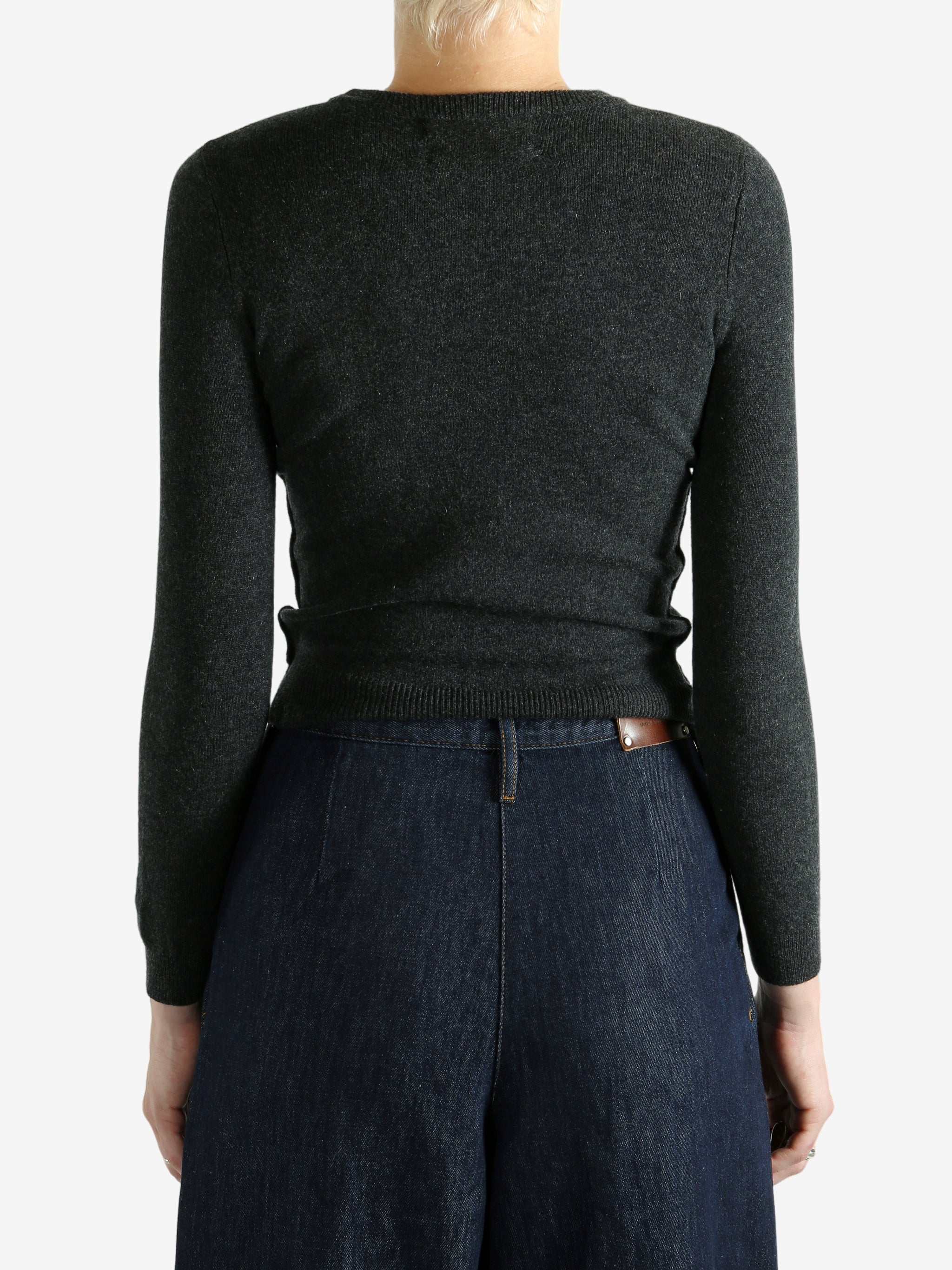 Grey sweater worn by a person, showing the sweater's fit