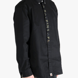 Black shirt worn by a person, showing the shirt's fit