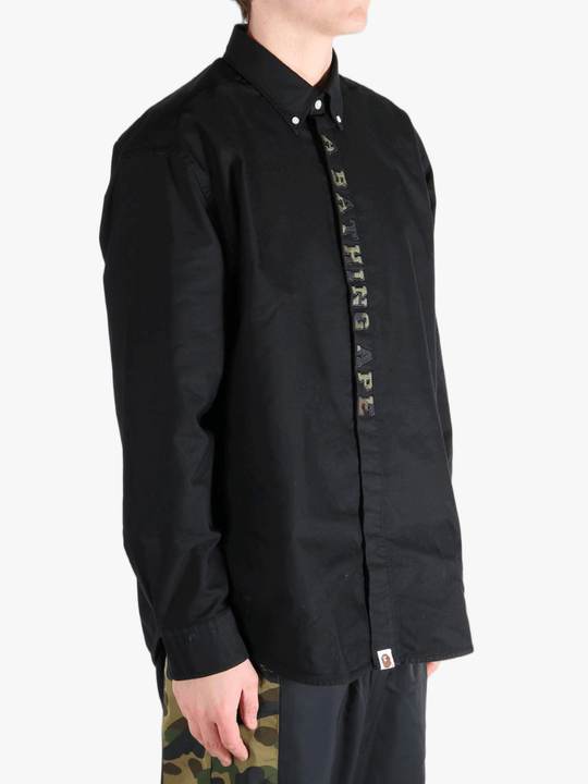 Black shirt worn by a person, showing the shirt's fit