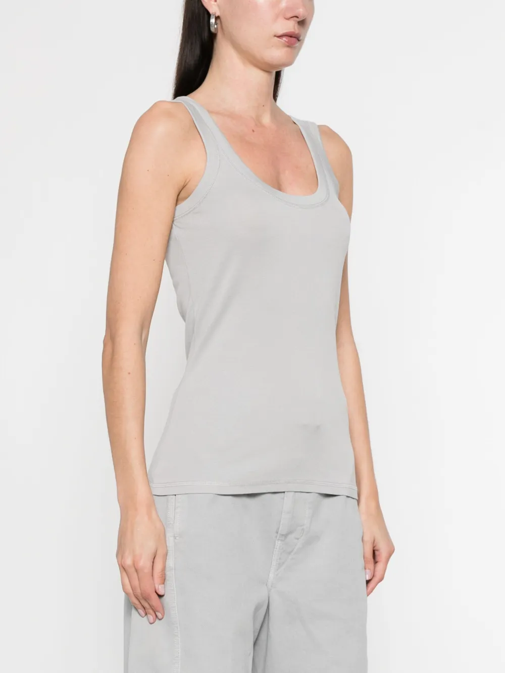 Grey tops worn by a person, showing the tops fit