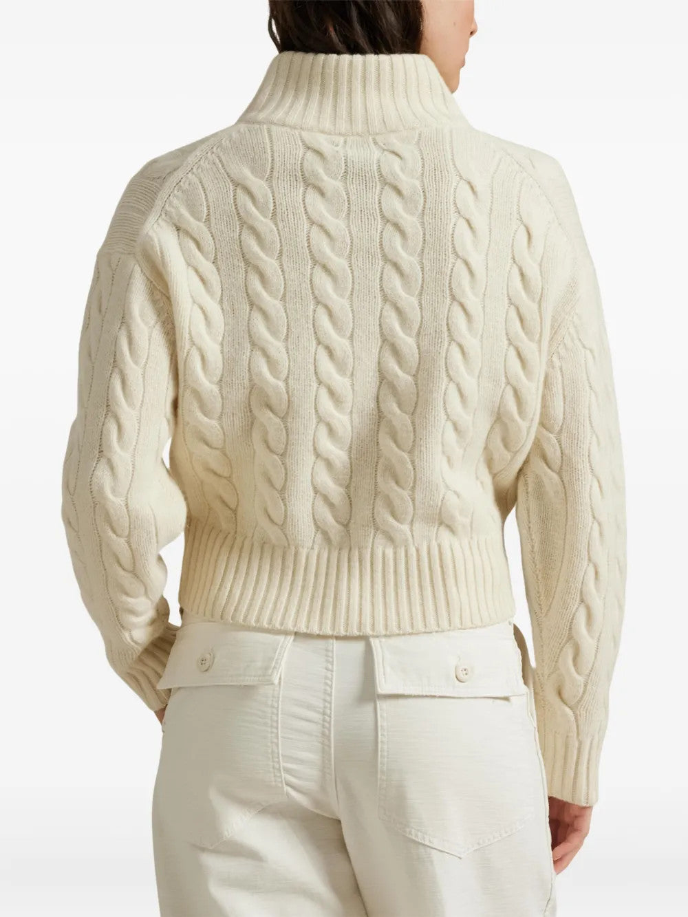 Tan knitwear worn by a person, showing the knitwear fit