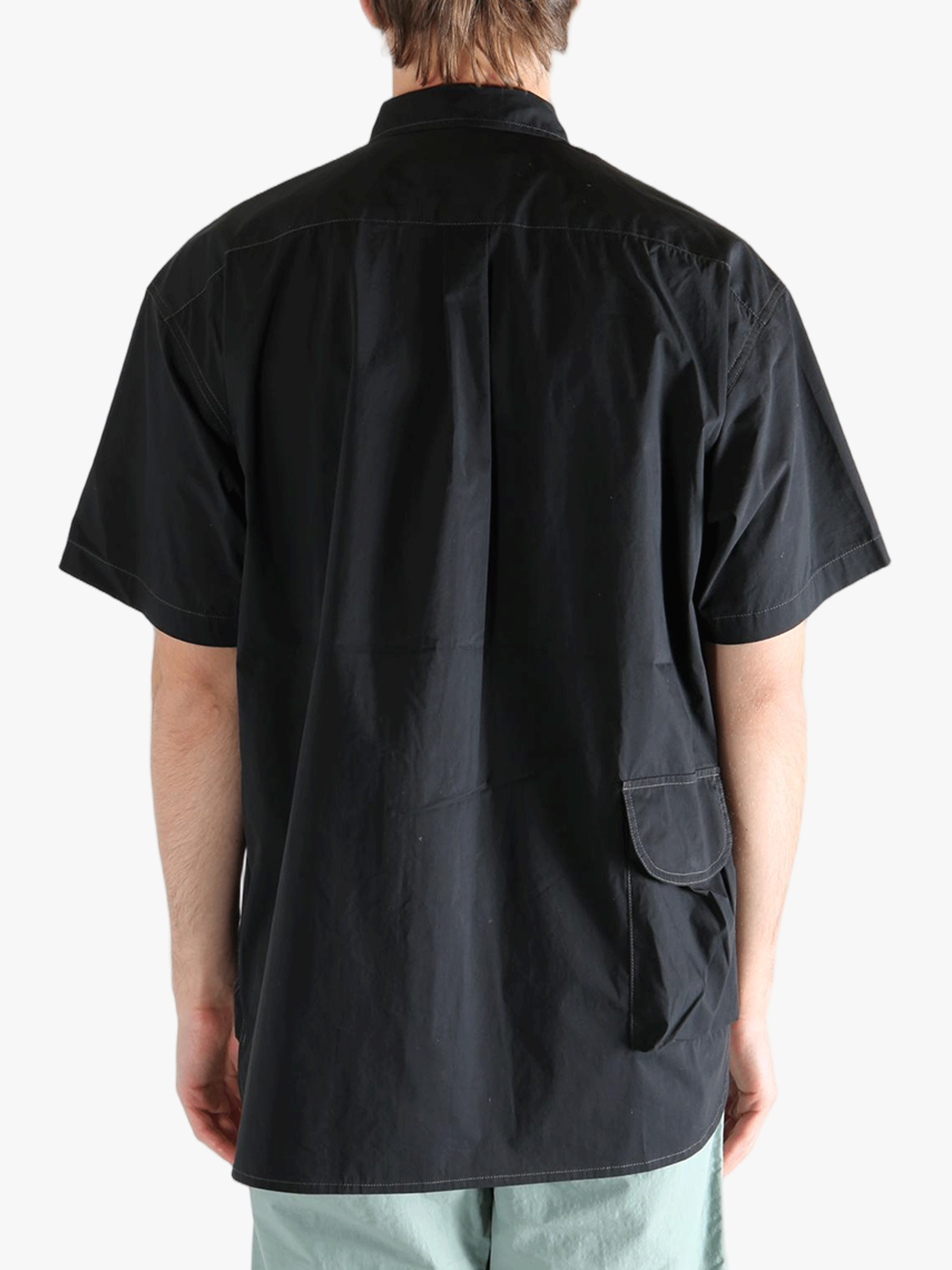 Black shirts worn by a person, showing the shirts fit