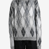 Grey knitwear worn by a person, showing the knitwear fit
