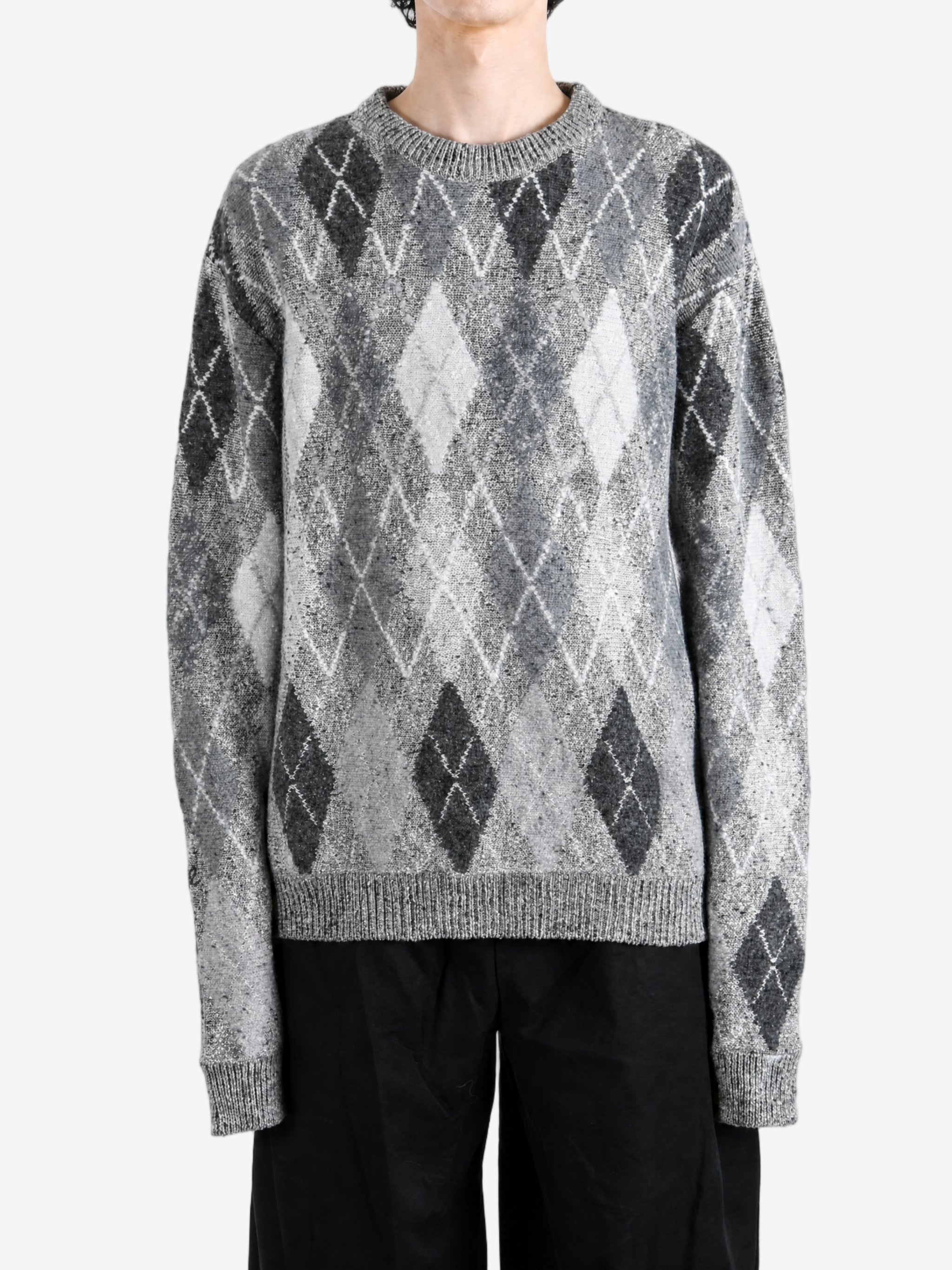 Grey knitwear worn by a person, showing the knitwear fit