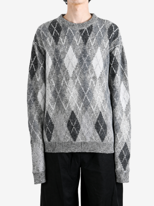 Grey knitwear worn by a person, showing the knitwear fit