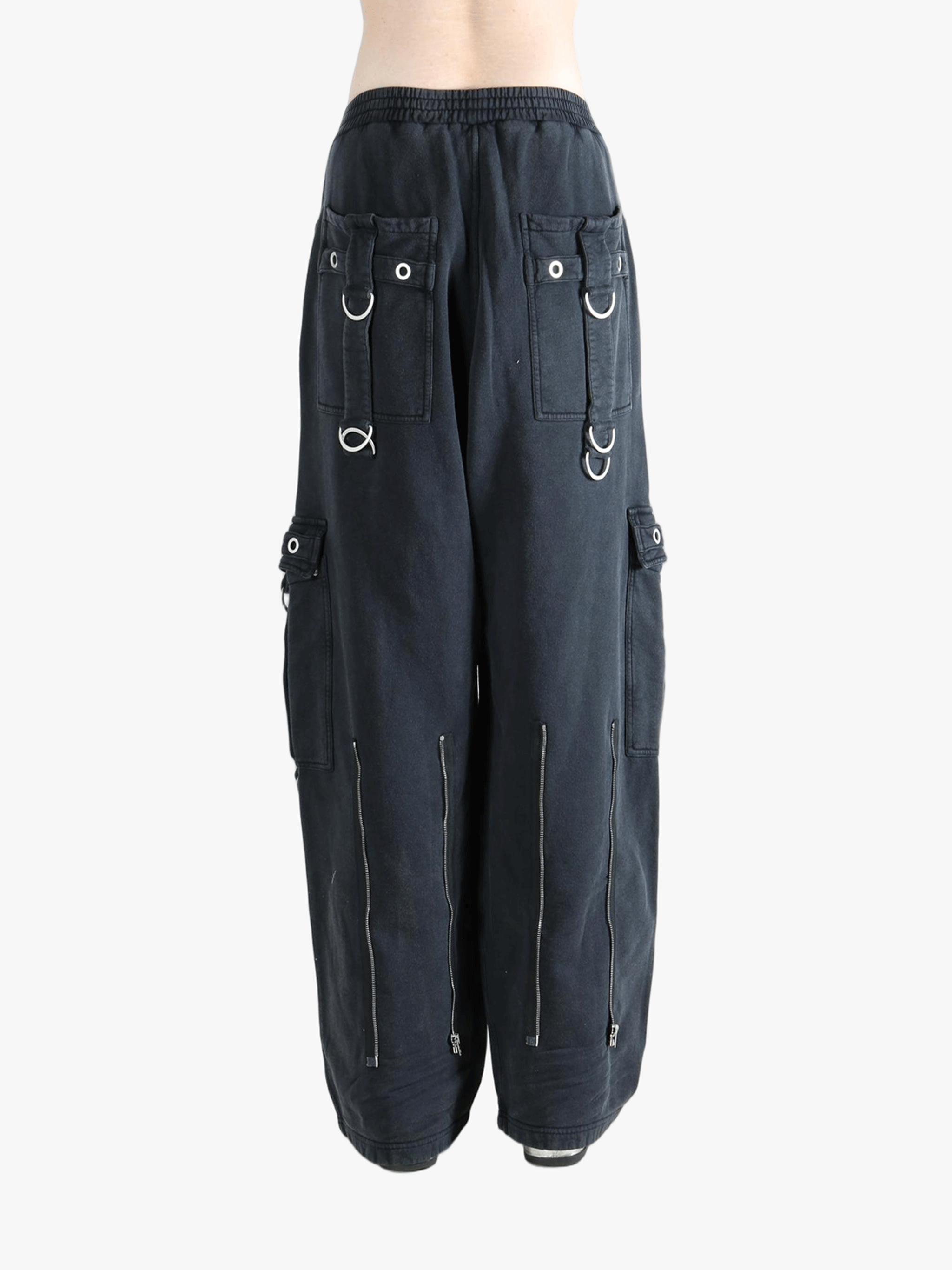 Black pants worn by a person, showing the pants' fit