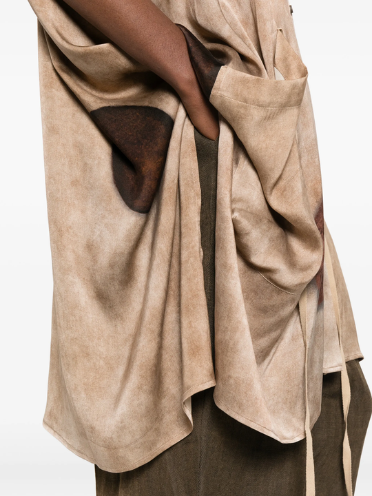 Brown top worn by a person, showing the top's fit