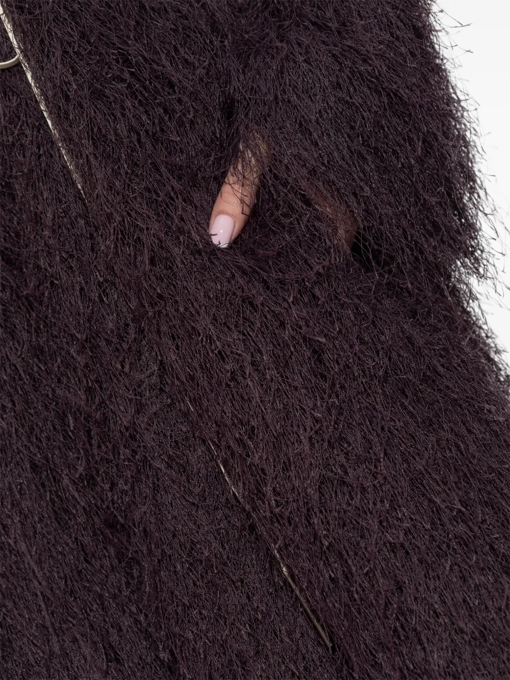 Close up of purple jacket-coat, showing texture of the polyester fabric