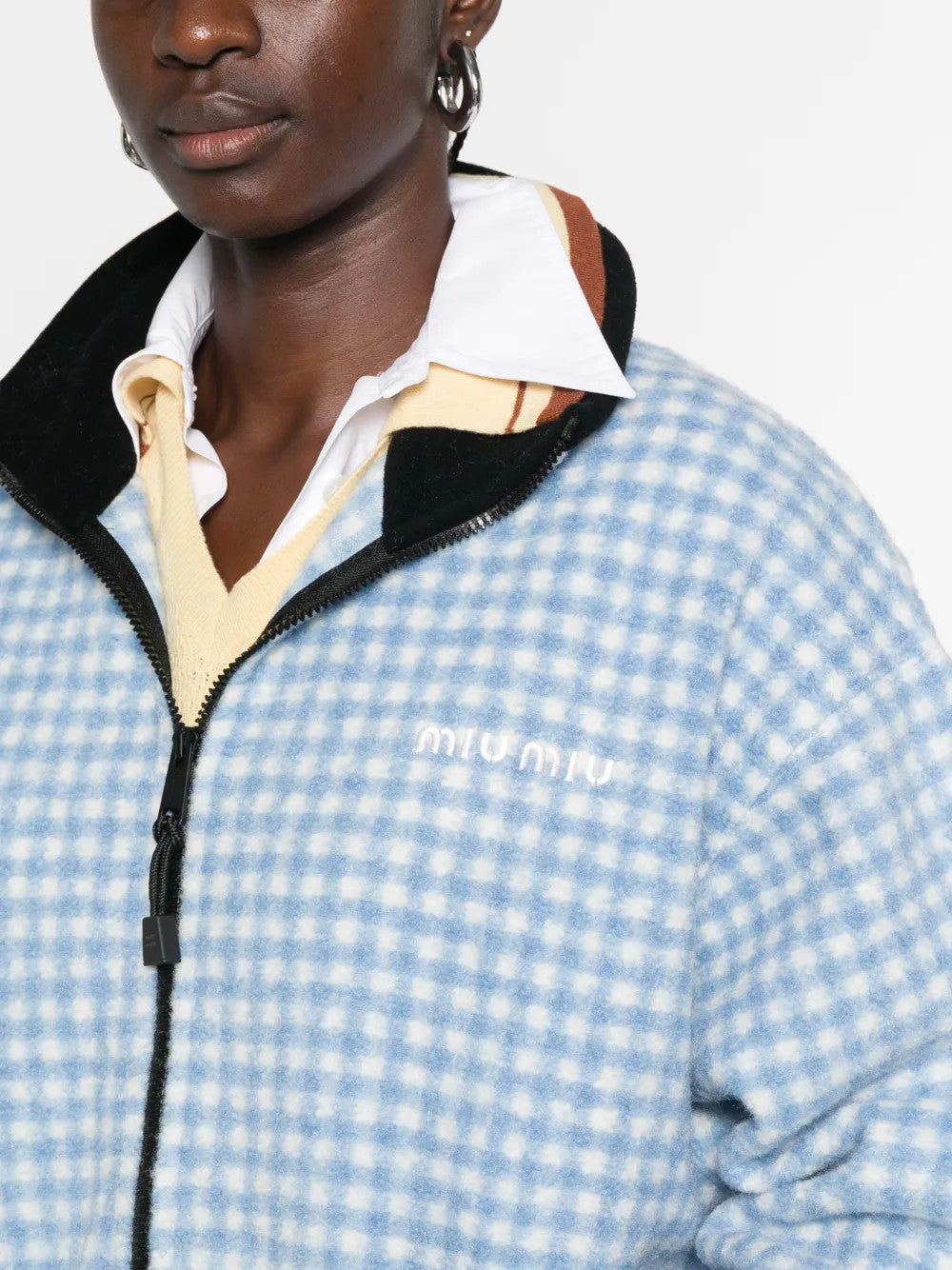 Blue jacket worn by a person, showing the jacket fit