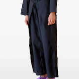 Black pants worn by a person, showing the pants's fit