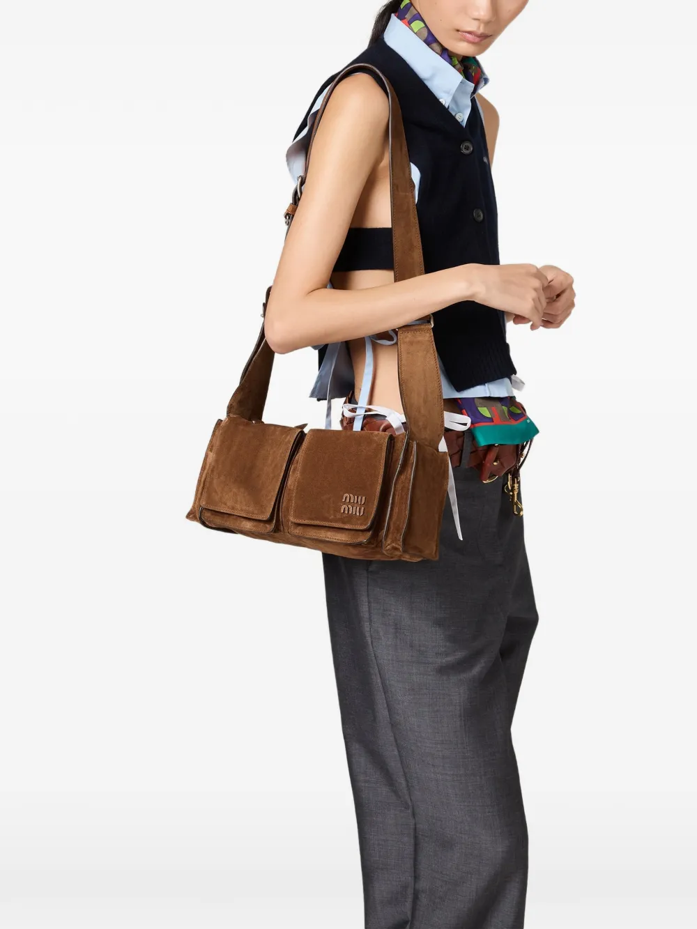 Brown leather bag worn by a person, showing the bag fit