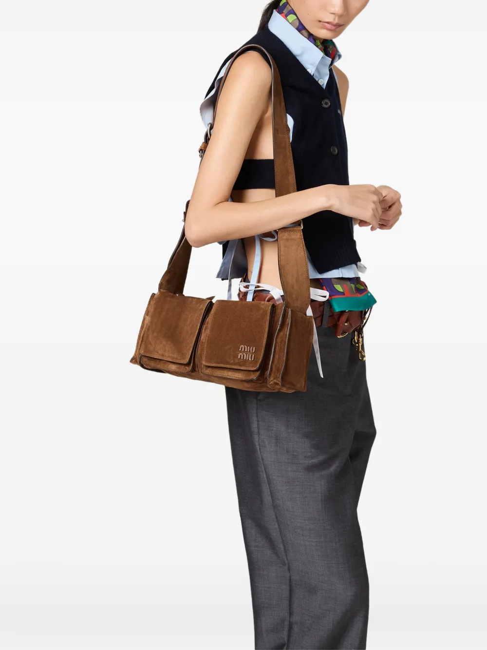 Brown leather bag worn by a person, showing the bag fit