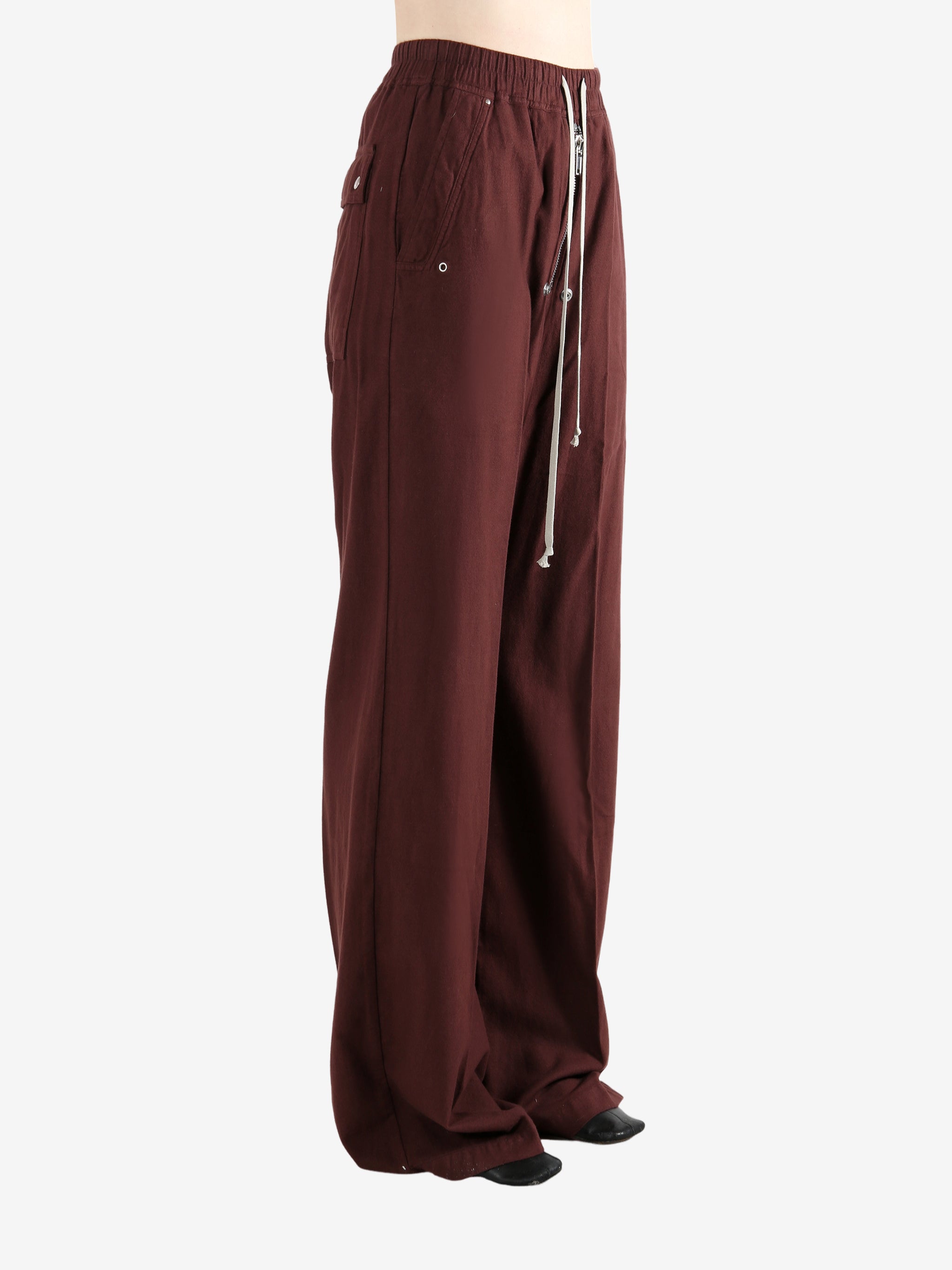 Burgundy pants worn by a person, showing the pants fit