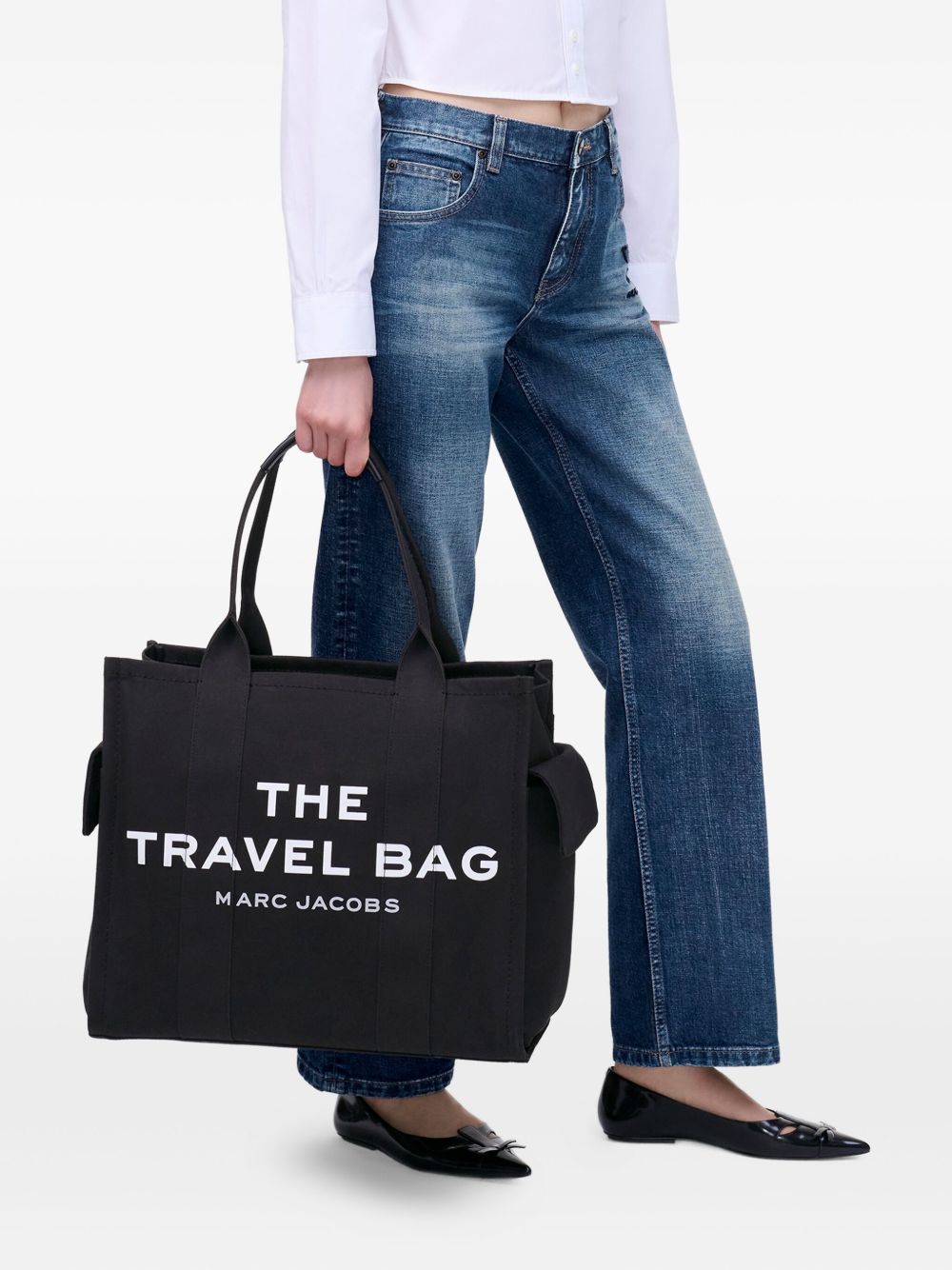 Black bag carried by a person, showing the bag’s fit