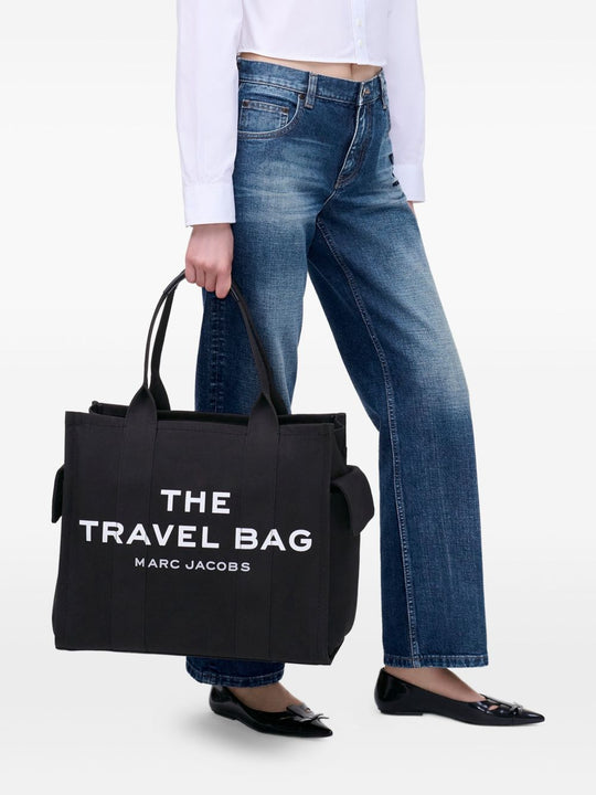 Black bag carried by a person, showing the bag’s fit