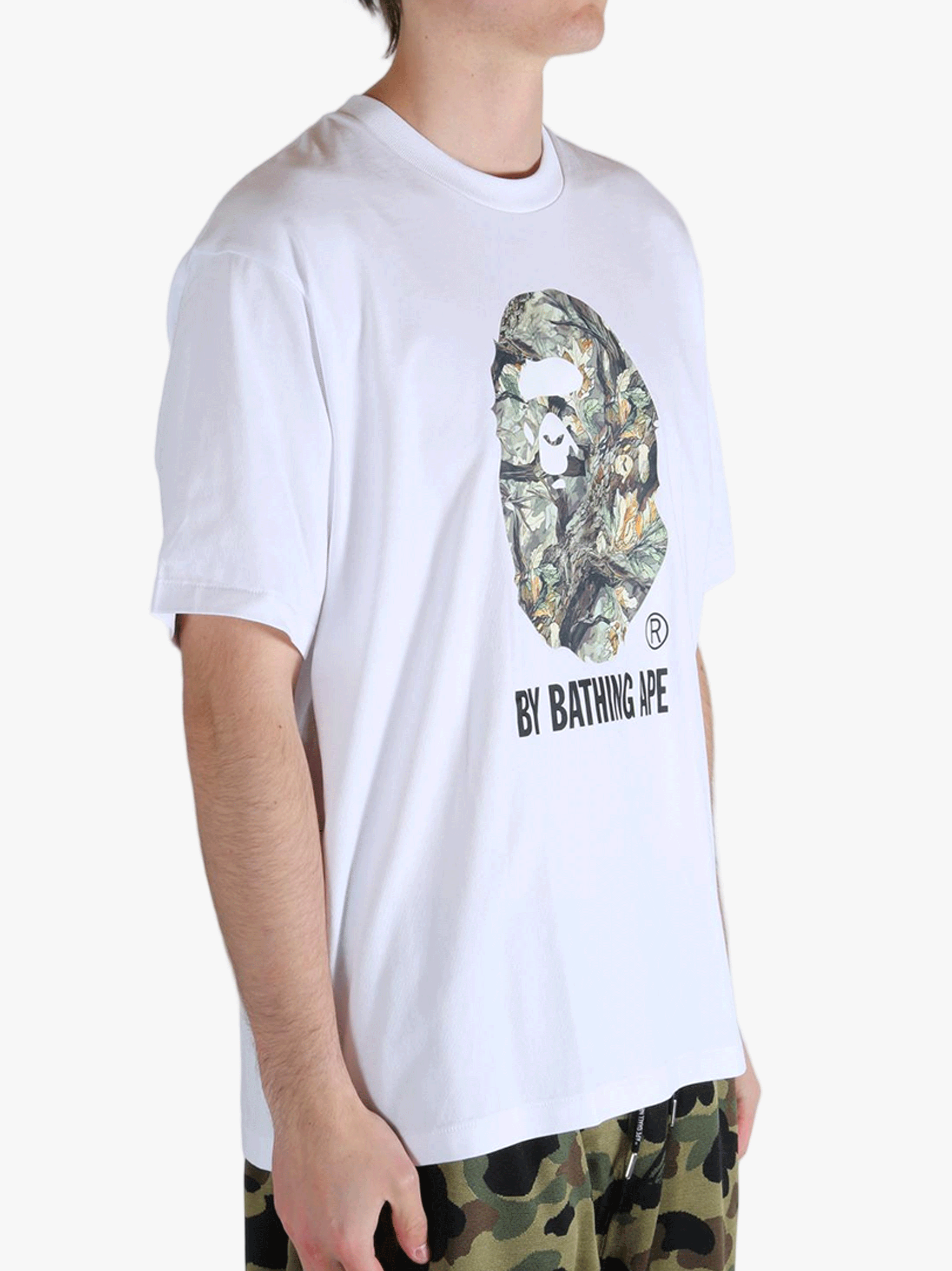 White t-shirt worn by a person, showing the t-shirt's fit