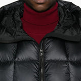 Close up of the black parka, showing texture of the nylon fabric