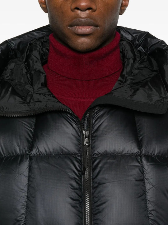 Close up of the black parka, showing texture of the nylon fabric