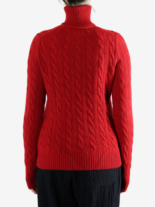 Red knitwear worn by a person, showing the knitwear's fit