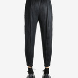 Black pants worn by a person, showing the pants' fit