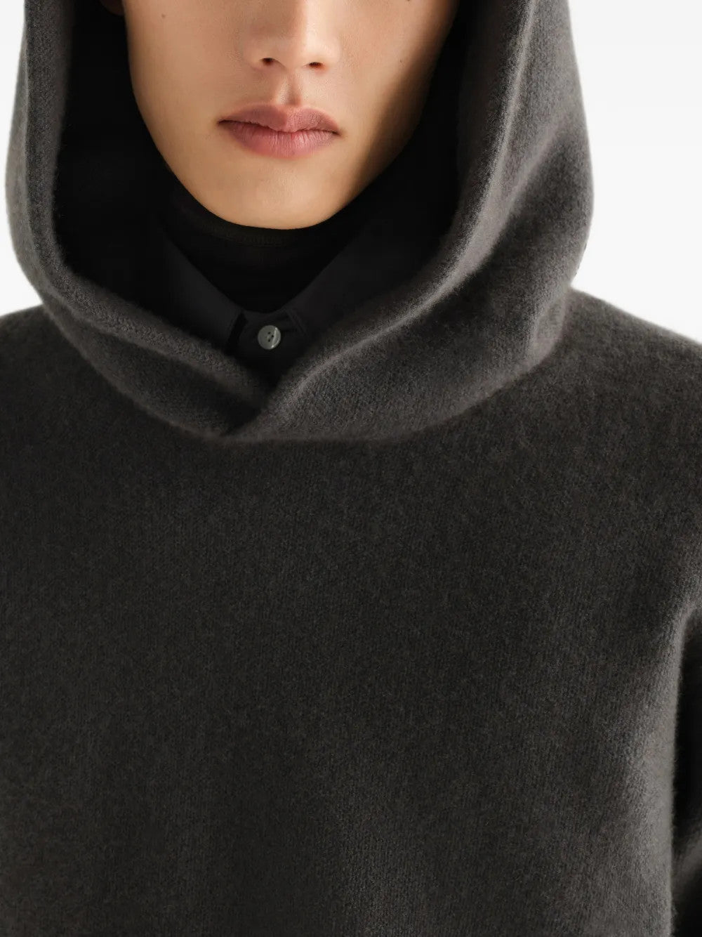 Grey knitwear worn by a person, showing the knitwear fit