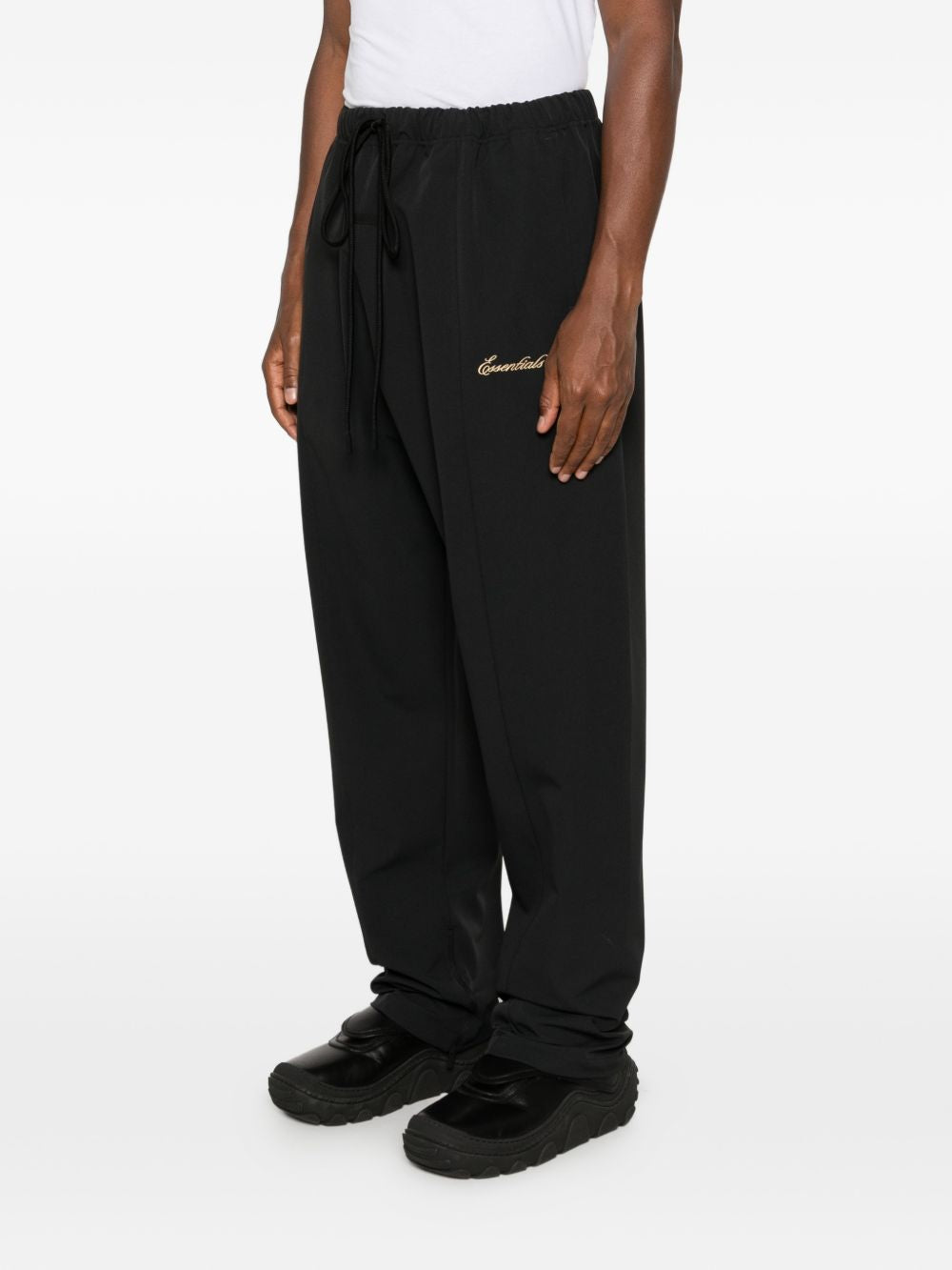 Black pants worn by a person, showing the pants' fit