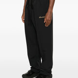 Black pants worn by a person, showing the pants' fit