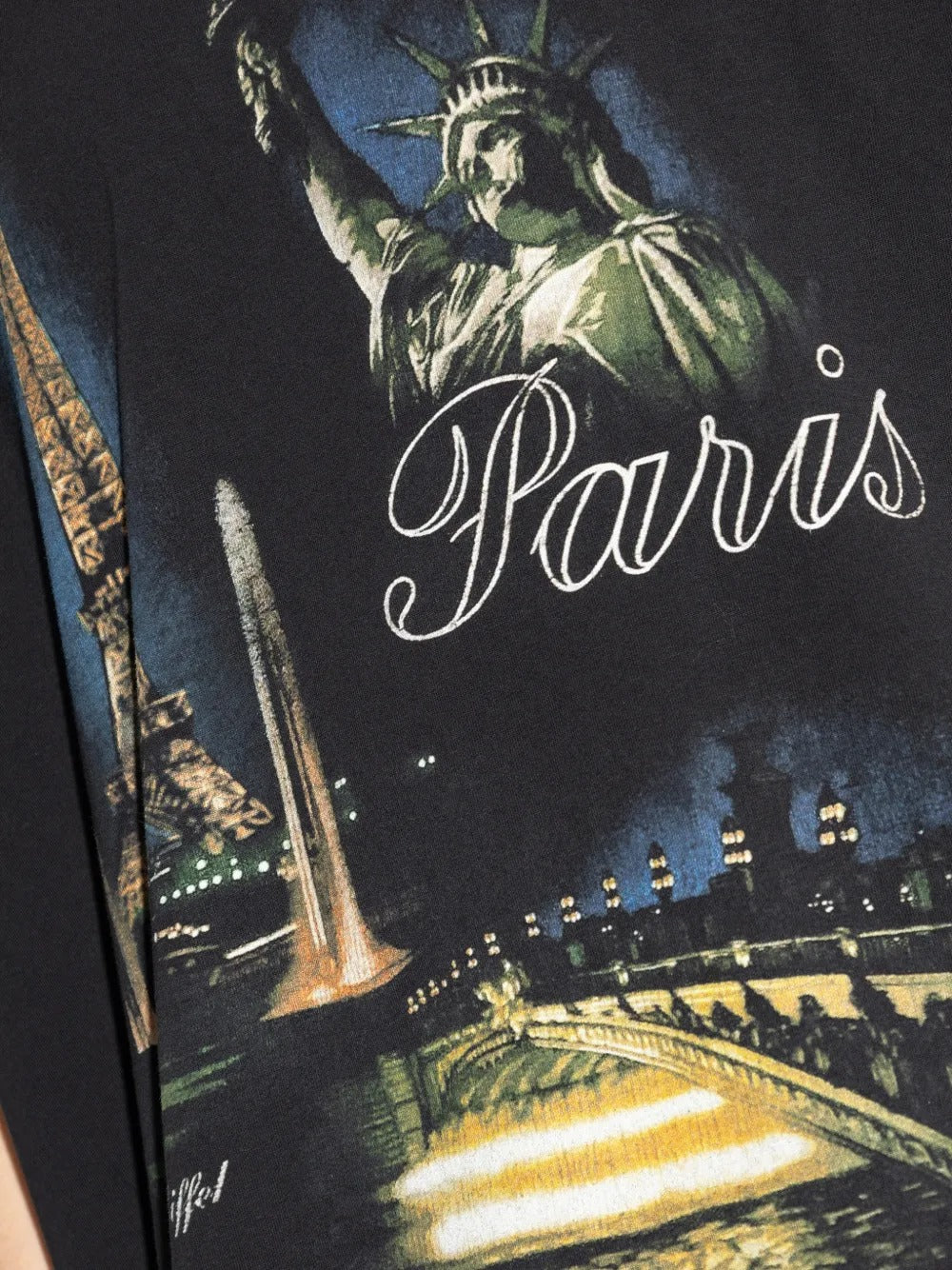 Close up of black t-shirts, showing texture of the cotton fabric