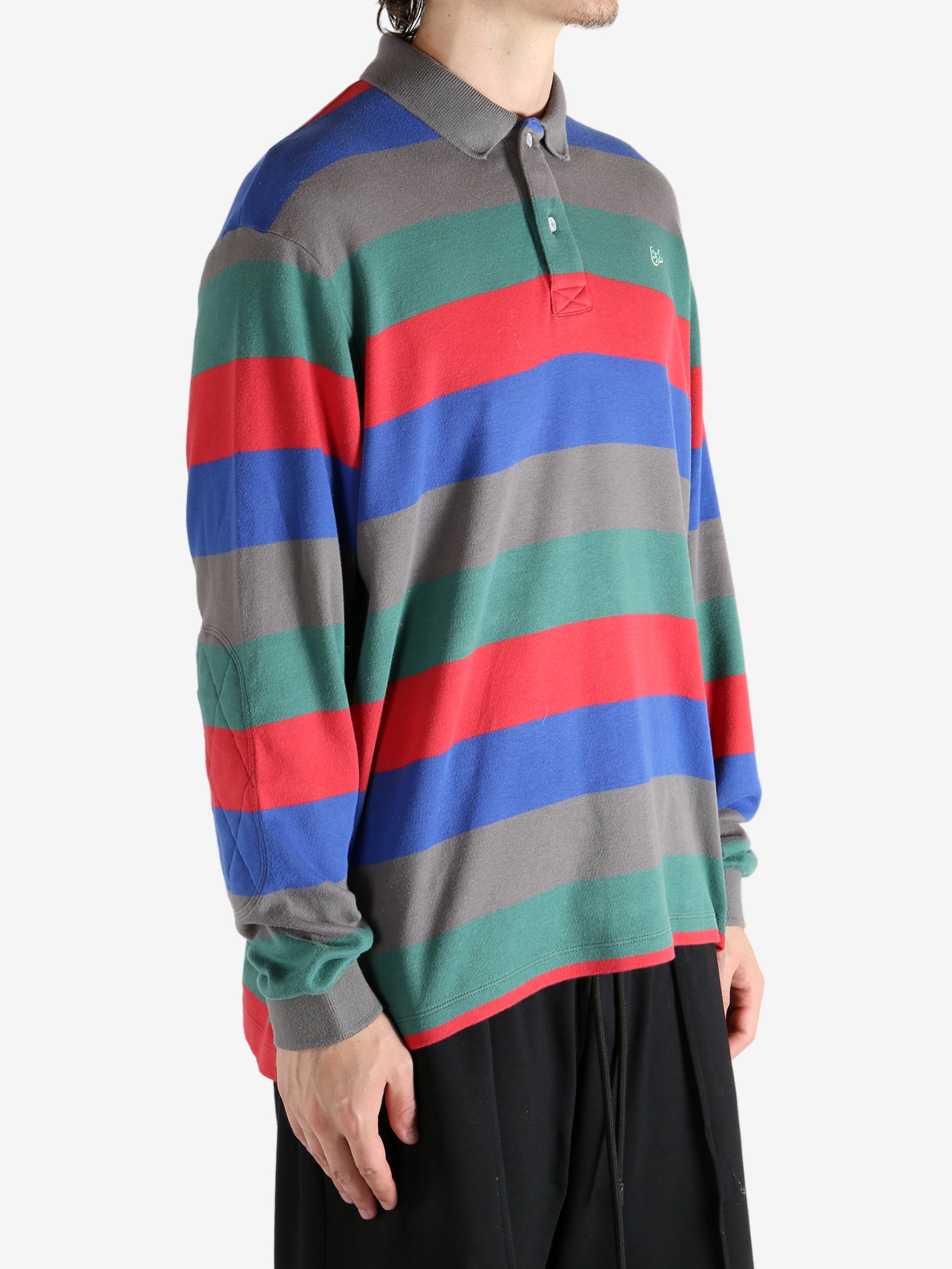 Grey shirt worn by a person, showing the shirt's fit