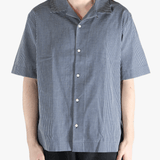 Blue checkered shirt worn by a person, showing the shirt's fit