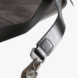 Close up of grey bag, showing texture of the leather fabric