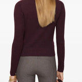 Red knitwear worn by a person, showing the knitwear's fit