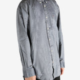 Grey shirt worn by a person, showing the shirt's fit