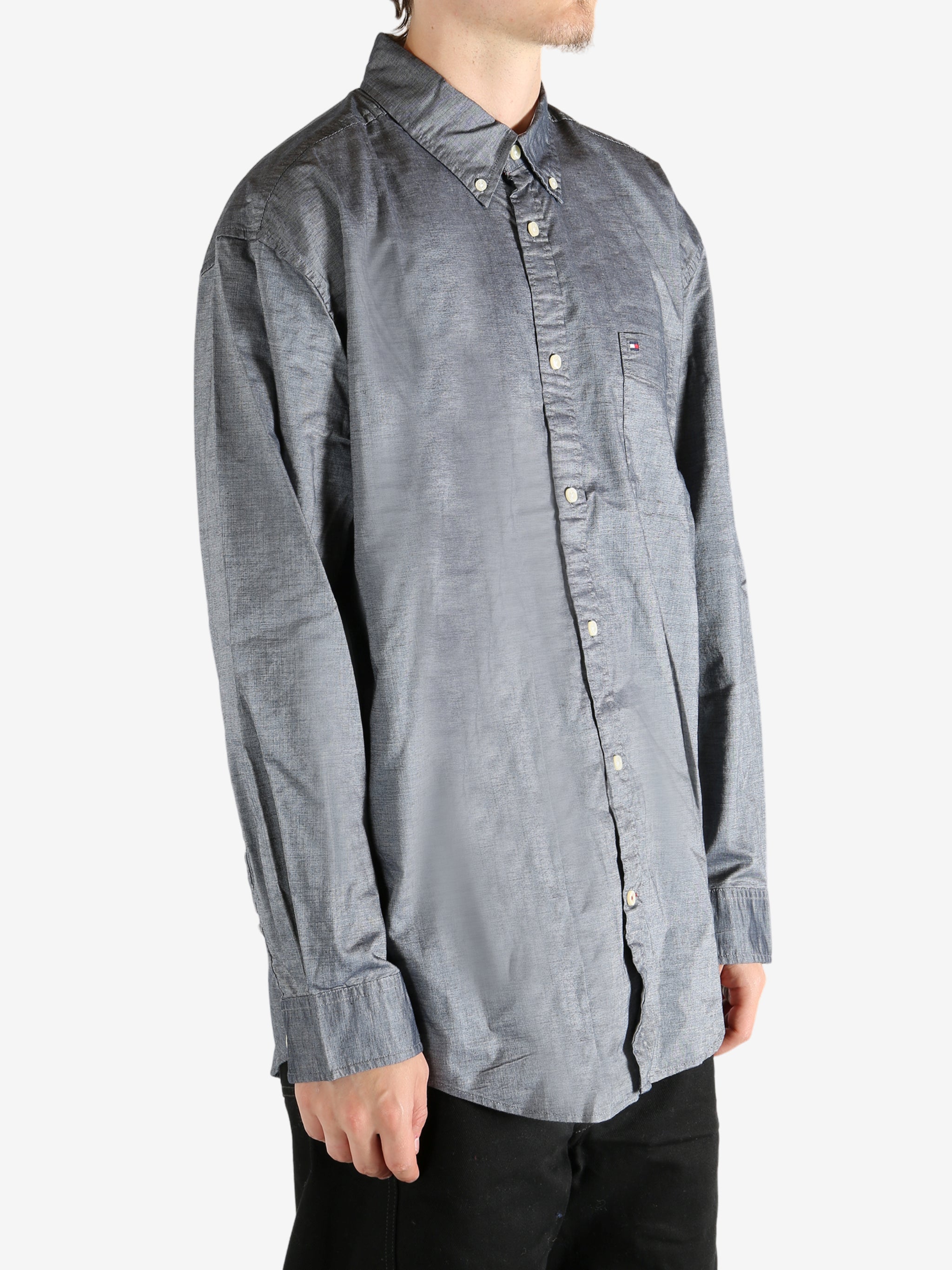 Grey shirt worn by a person, showing the shirt's fit