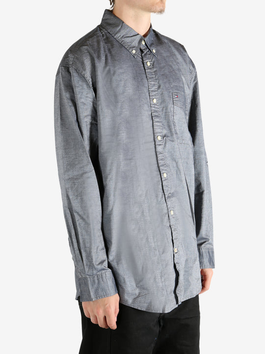 Grey shirt worn by a person, showing the shirt's fit