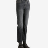 Black jeans worn by a person, showing the jean's fit