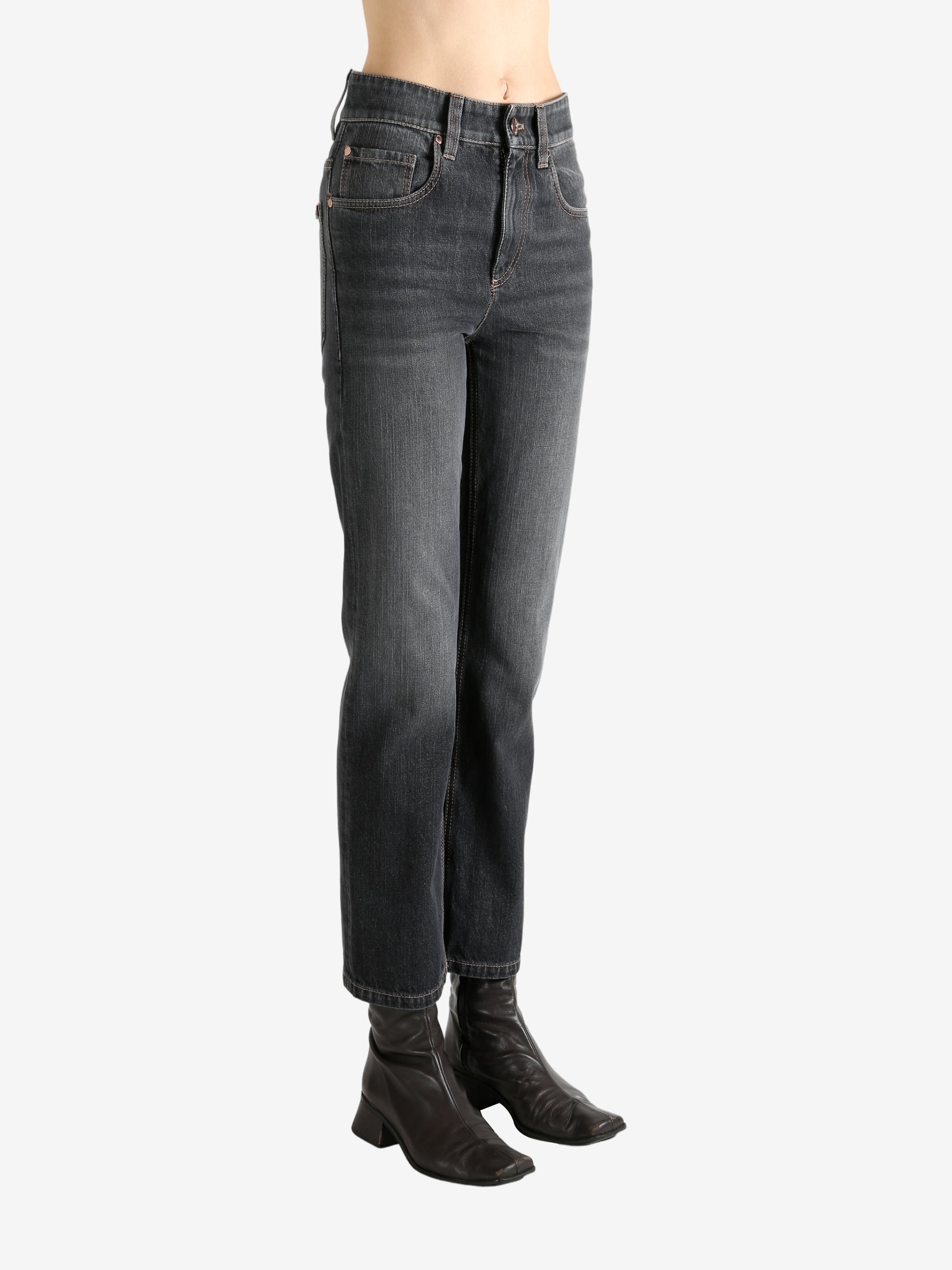 Black jeans worn by a person, showing the jean's fit
