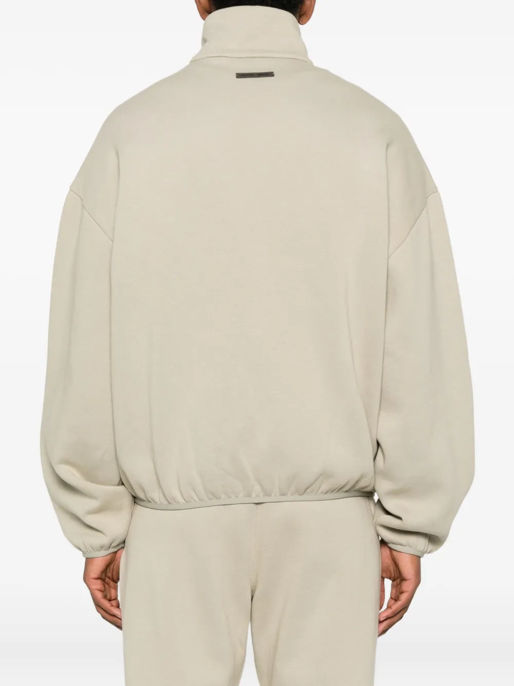 Grey jacket worn by a person, showing the jacket fit