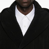 Close up of black blouson, showing texture of the cotton fabric