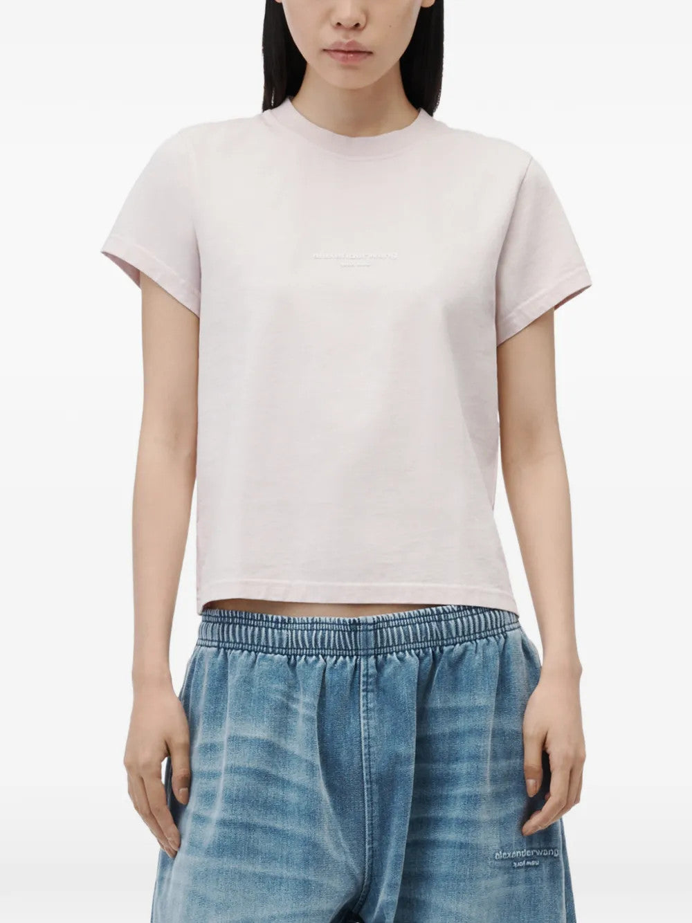Pink t-shirt worn by a person, showing the t-shirt fit