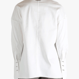 White shirt worn by a person, showing the shirt's fit