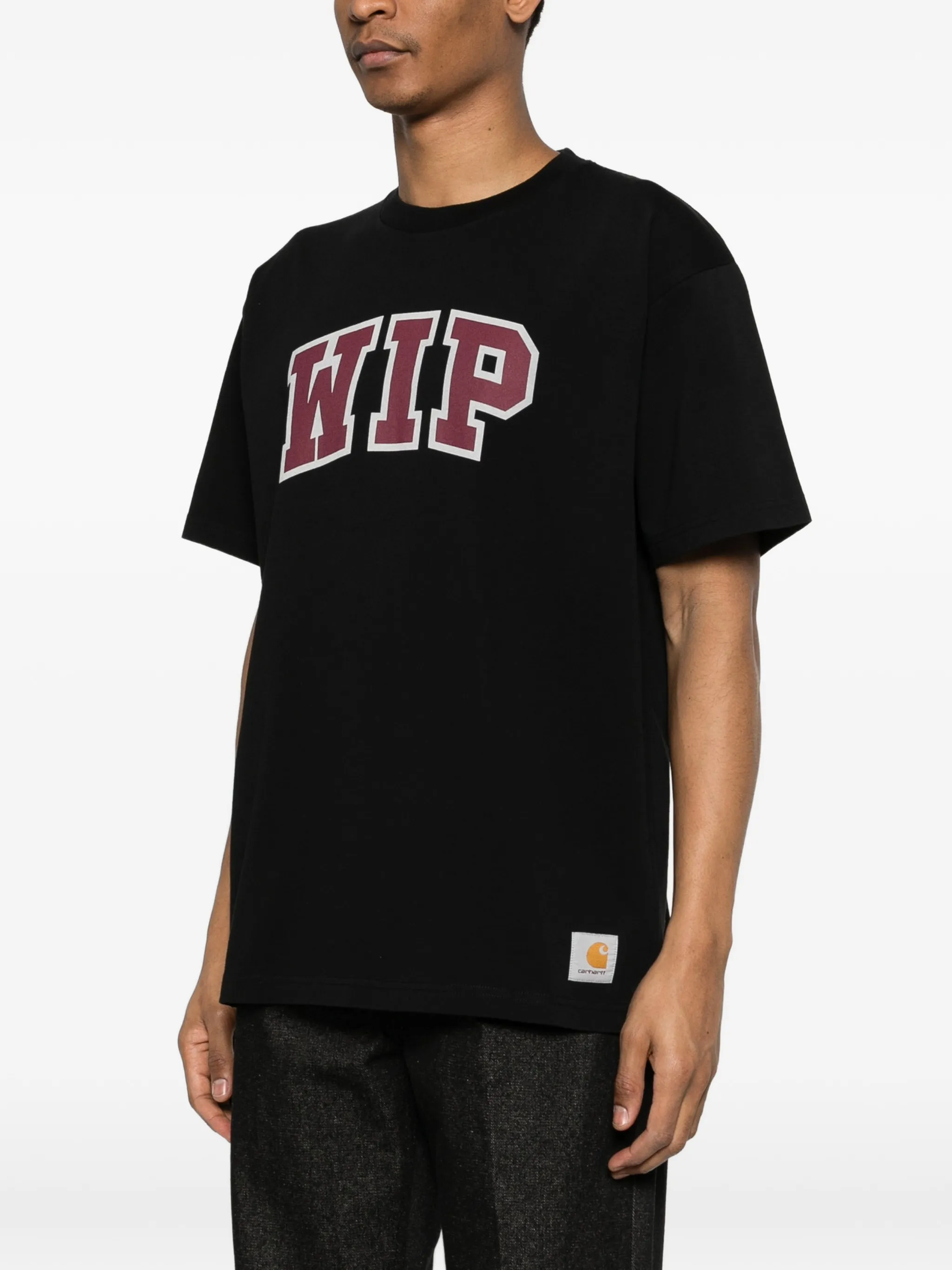 Black t-shirt worn by a person, showing the t-shirt's fit