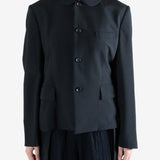 Black jacket worn by a person, showing the jacket fit