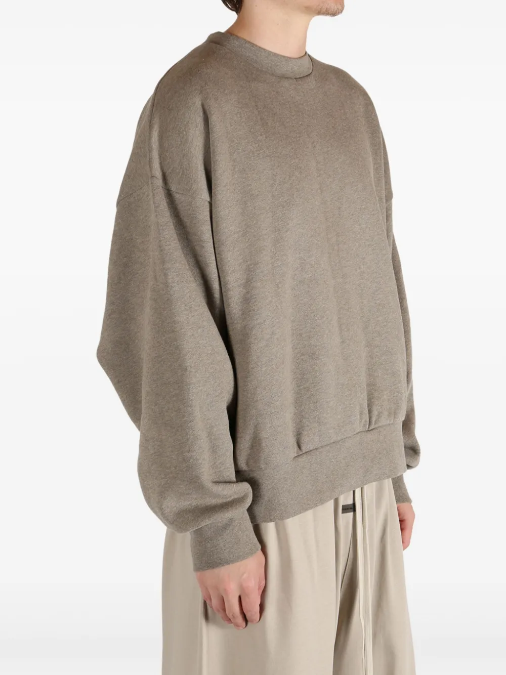 Brown top worn by a person, showing the top's fit