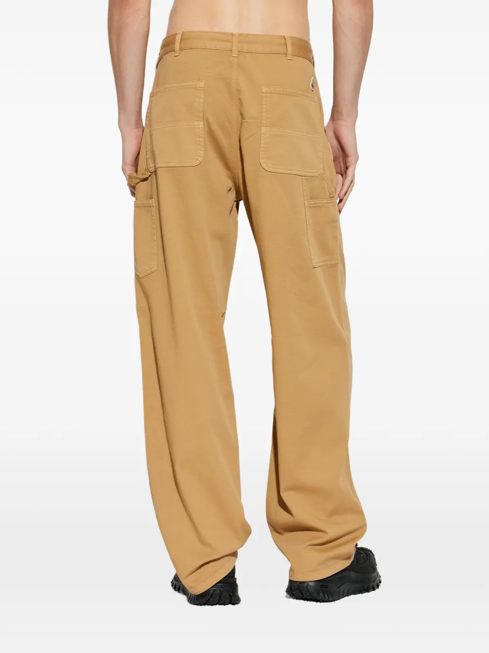 brown pants worn by a person, showing the pants fit